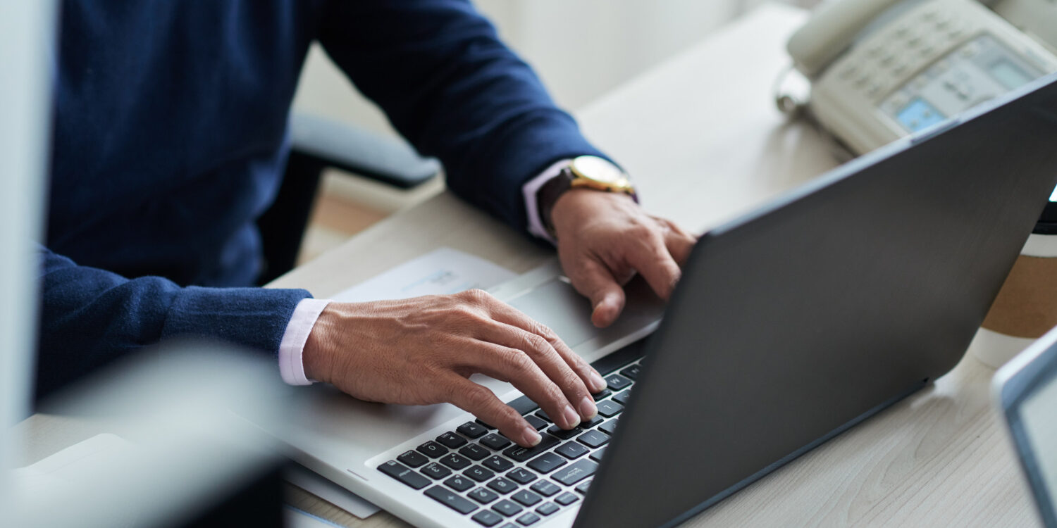 high-angle-view-cropped-employee-work-with-laptop